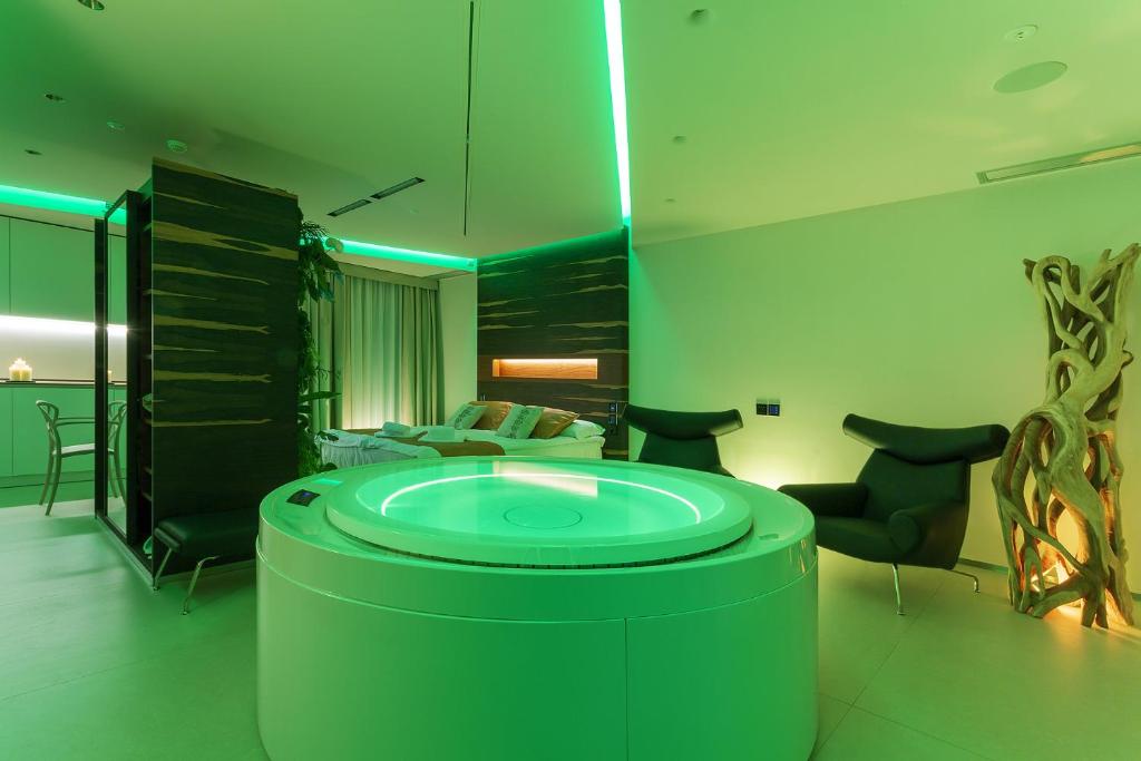 a bathroom with a large tub in the middle of a room at Costa Rica Bibione SPA in Bibione