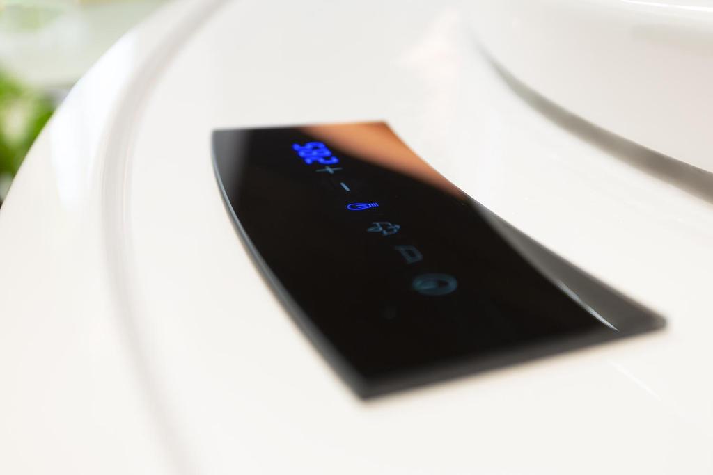 a close up of a remote control in a white car at Costa Rica Bibione SPA in Bibione