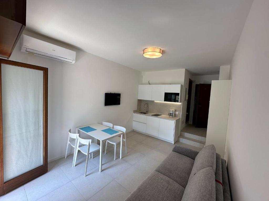 a living room with a couch and a table at Residence Bristol Bibione in Bibione