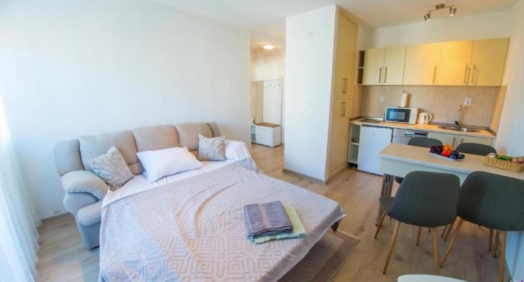 a living room with a bed and a kitchen at Francis First in Mostar