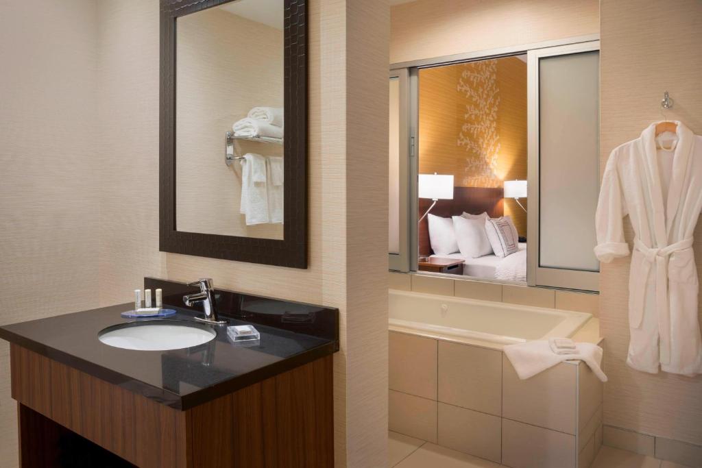 a bathroom with a sink and a bath tub at Fairfield Inn & Suites by Marriott Ottawa Kanata in Ottawa