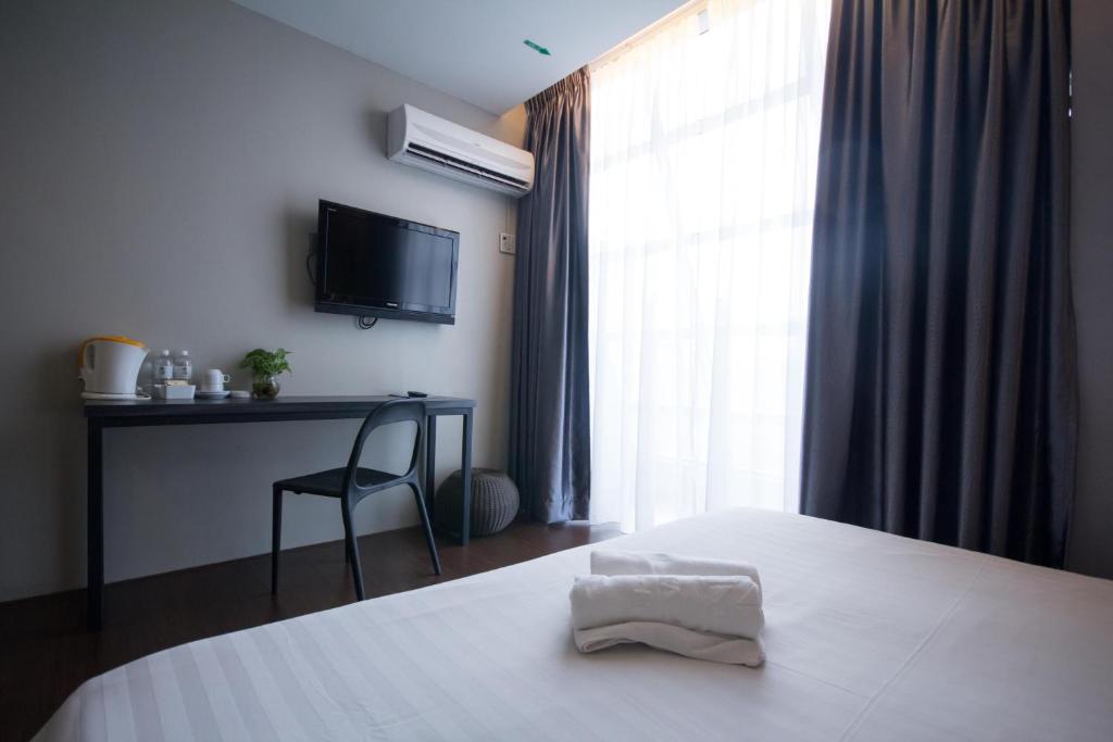 Postel nebo postele na pokoji v ubytování Chariton Hotel Ipoh
