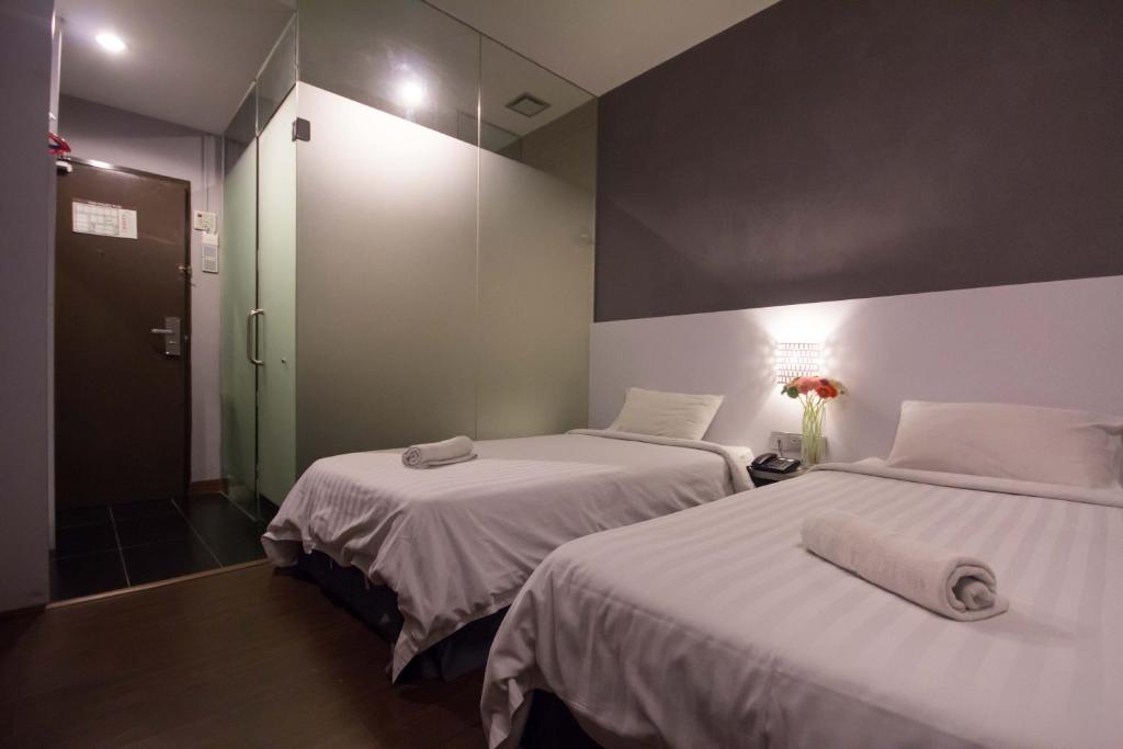 Postel nebo postele na pokoji v ubytování Chariton Hotel Ipoh