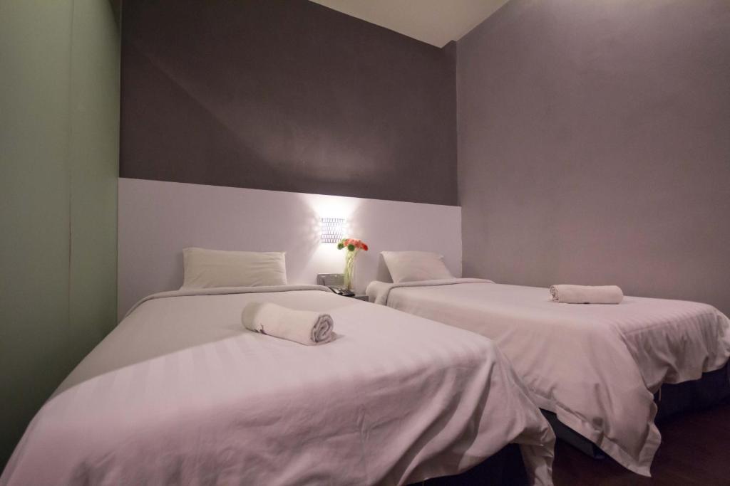 Postel nebo postele na pokoji v ubytování Chariton Hotel Ipoh