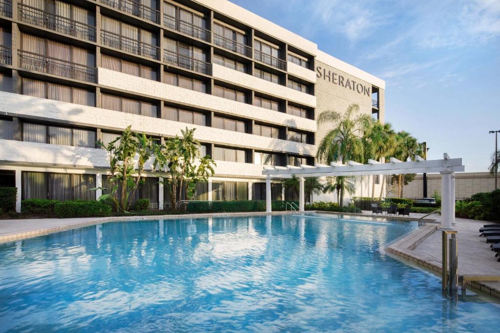 a large swimming pool in front of a building at Sheraton Orlando North in Orlando