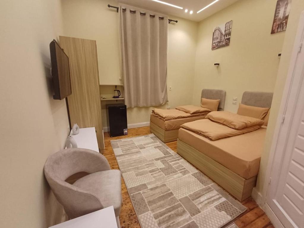 a small living room with two beds and a couch at Cairo Hub in Cairo