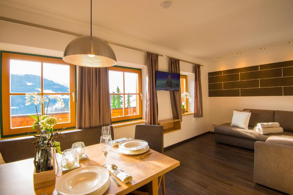 a living room with a table and a couch at Kendlhof in Sankt Johann im Pongau