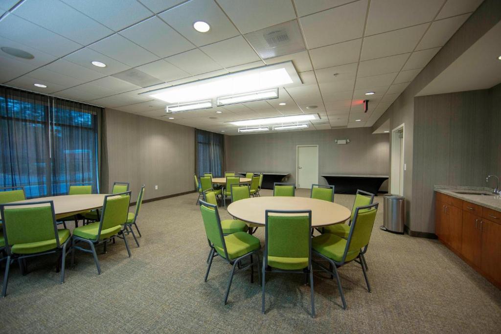 a conference room with tables and green chairs at SpringHill Suites by Marriott Athens West in Athens