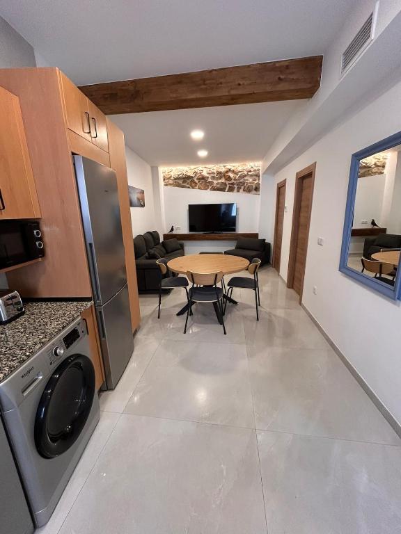 a kitchen and living room with a table and a dining room at Apartamento La Fragua - A ESTRENAR - BRAND NEW in Chulilla