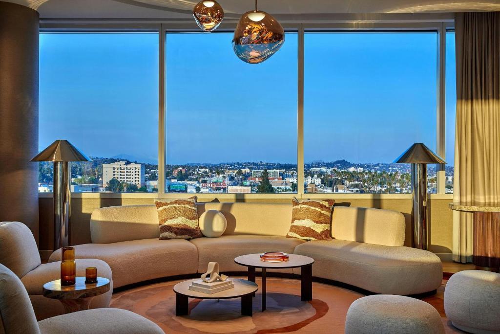 a living room with a couch and a large window at W Hollywood in Los Angeles