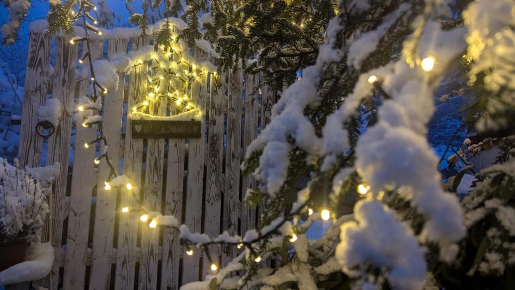 a building covered in snow with lights on it at Gemütliche Waldrandlage in Badenweiler Sehringen Ferienwohnung in Badenweiler