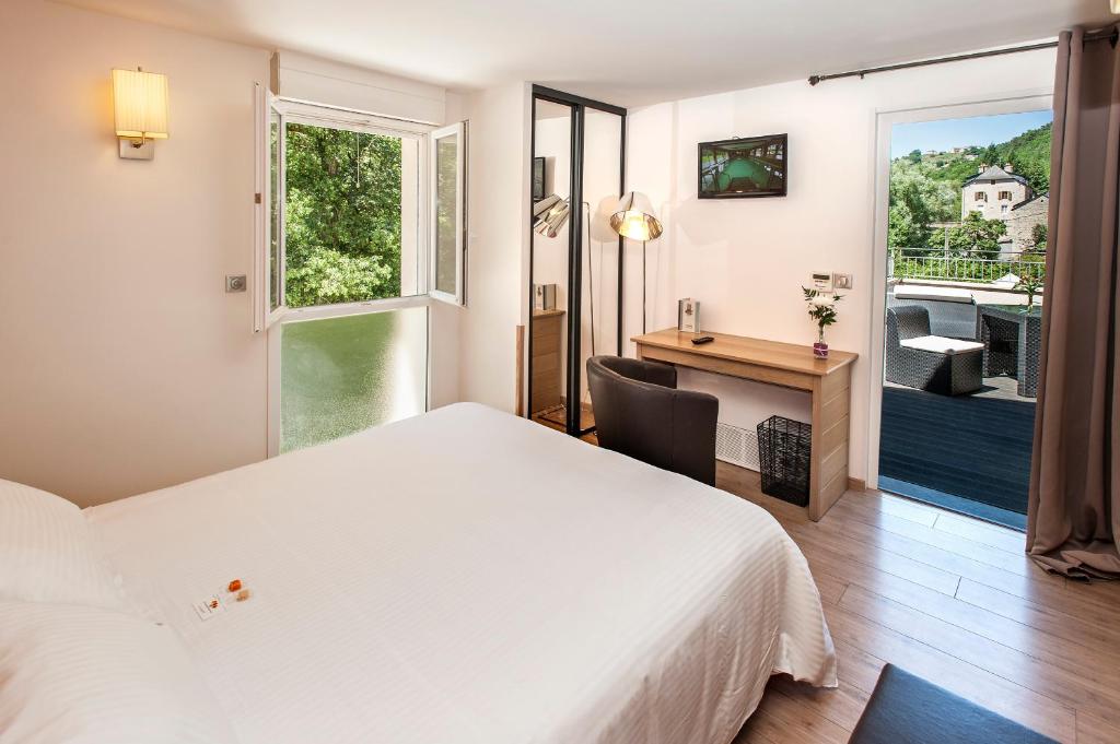 Postel nebo postele na pokoji v ubytování Logis Hôtel Restaurant Les 2 Rives - A75, en bordure de rivière
