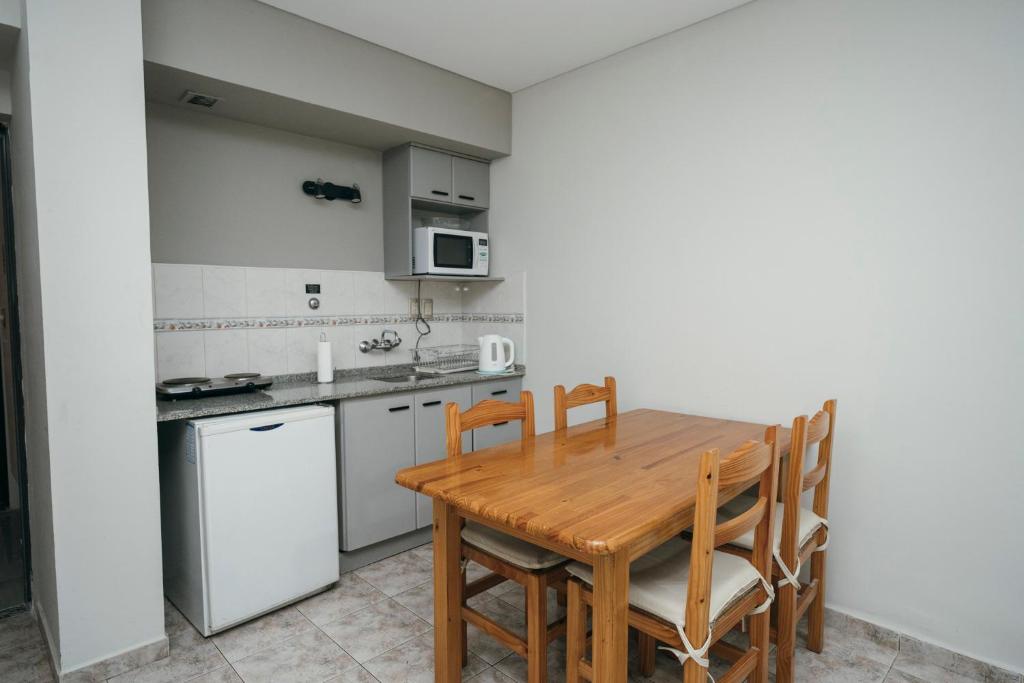 a kitchen with a wooden table and chairs at PM departamentos in San Rafael