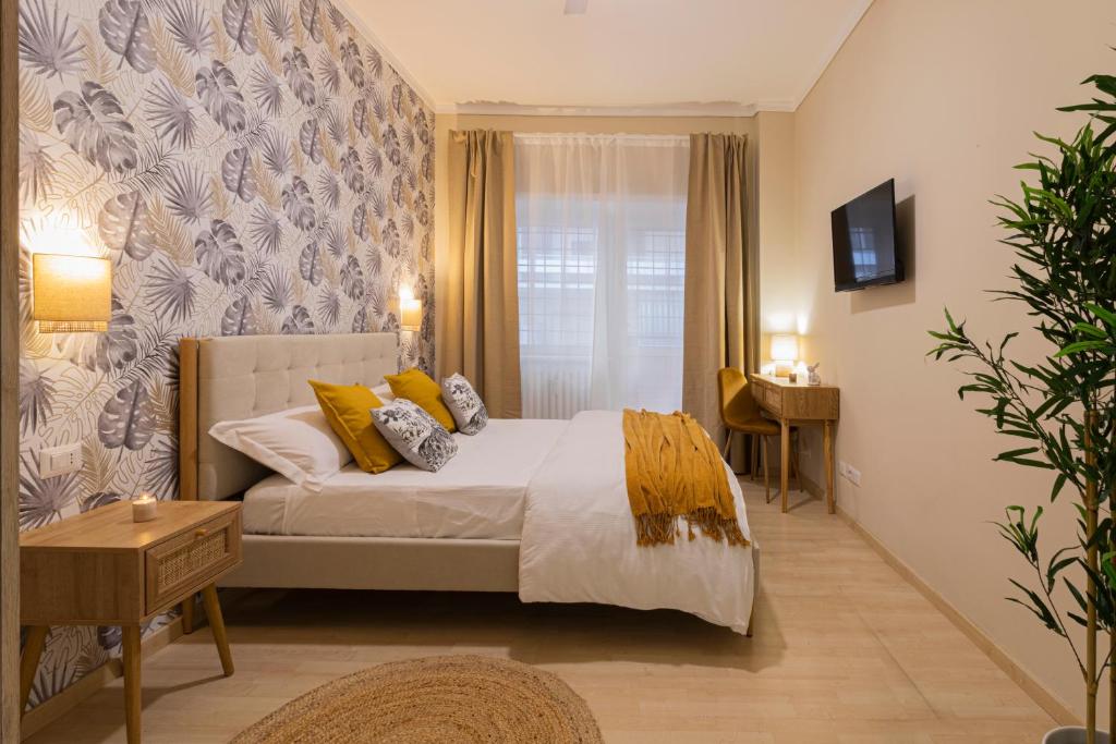 a bedroom with a large bed with yellow pillows at Anastasia Comfort at the Vatican with Balcony in Rome