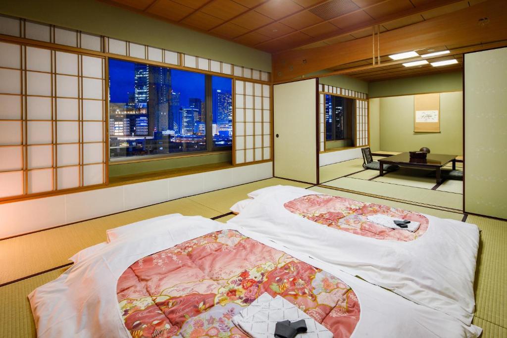 a room with a bed with a view of a city at The Westin Osaka in Osaka