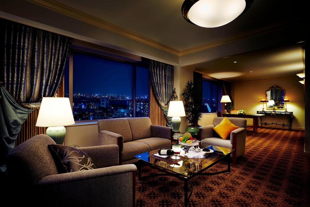 a living room with a couch and chairs and a table at The Westin Osaka in Osaka
