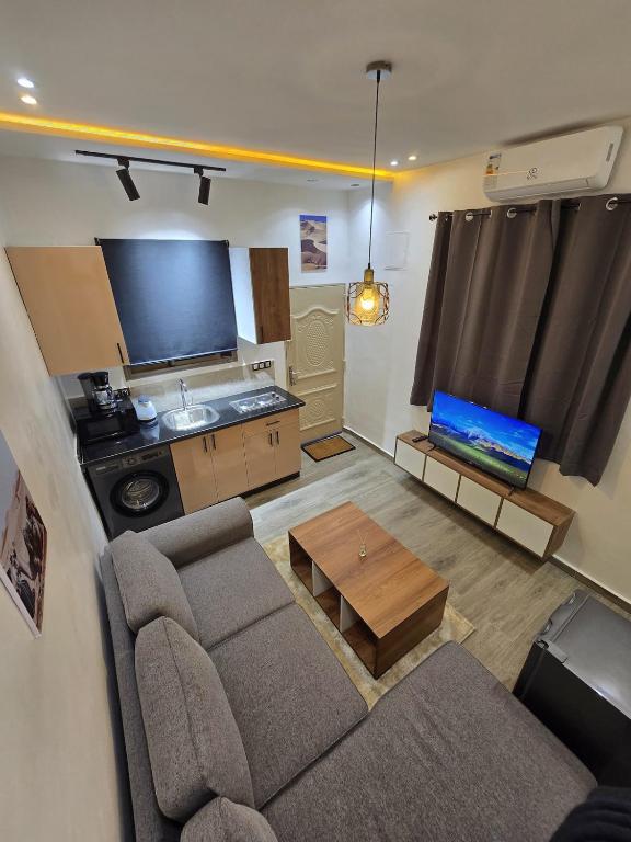 a living room with a couch and a table at Scenic Tamraght Cozy Studio in Agadir