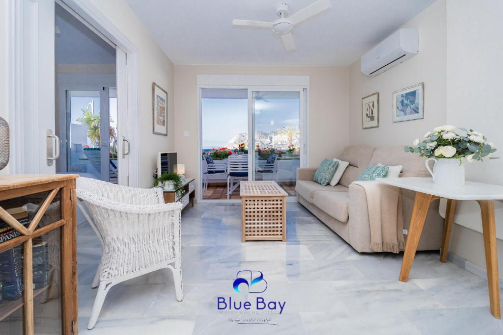 a living room with a couch and a table at Bliss On The Bay Apartment in La Herradura