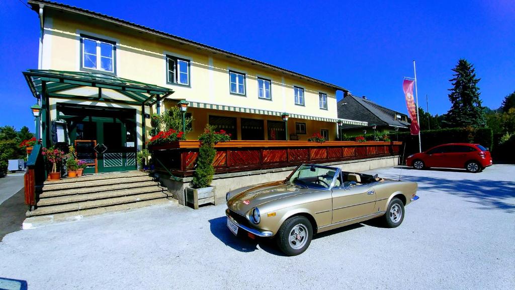 a vintage car parked in front of a house at Gasthof Linko in Traisen