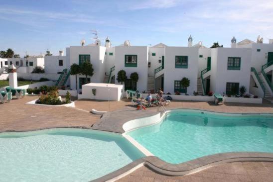 a large swimming pool in front of a building at Casa Paola in Tías