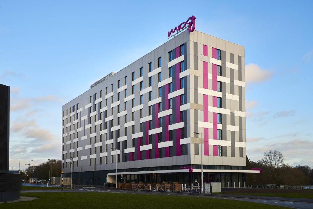 a hotel building with a sign on top of it at Moxy Birmingham NEC and Airport in Bickenhill