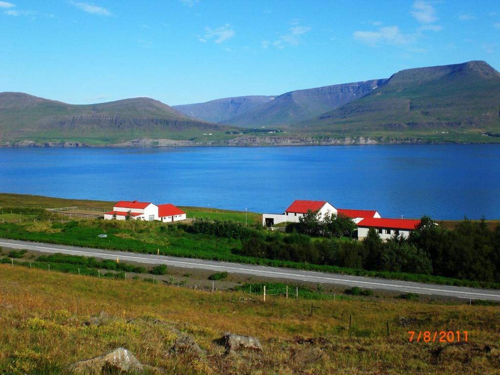 a large body of water with houses and a road at Námshestar in Kuludalsa