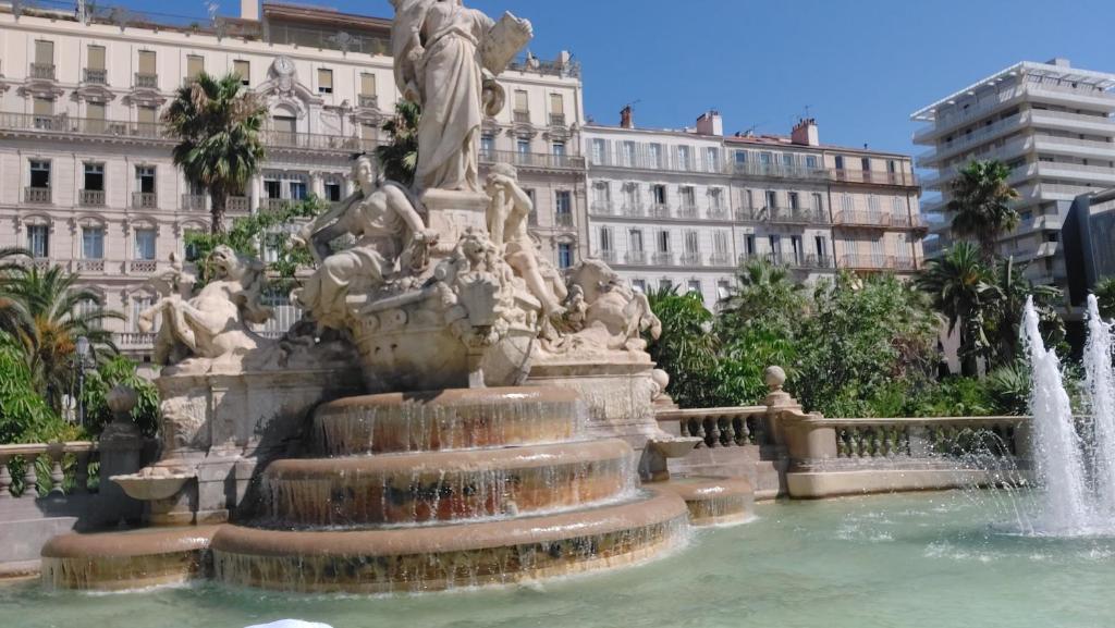 une fontaine en face d'un bâtiment avec des cascades dans l'établissement Appartement Toulon, à Toulon