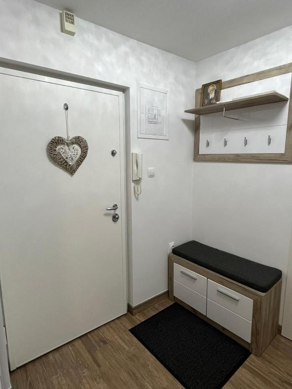 a room with a door with a heart on the wall at Apartman Matea - Self Check-in in Osijek