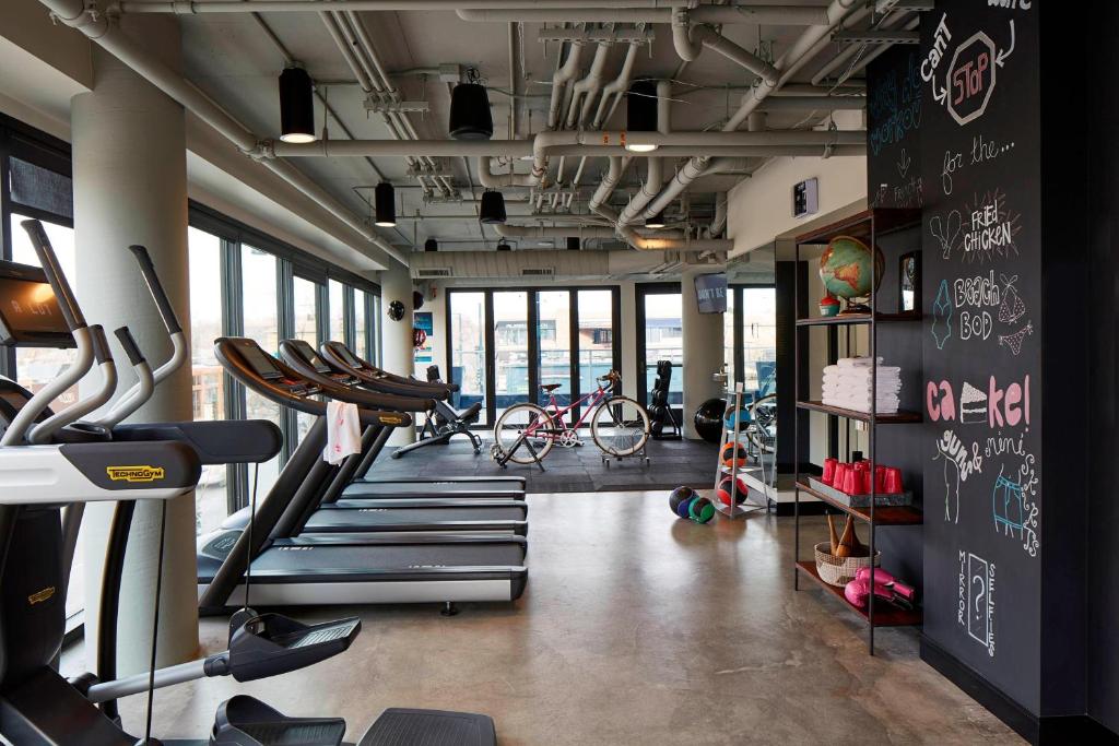 a gym with a bunch of cardio equipment in it at MOXY Denver Cherry Creek in Denver