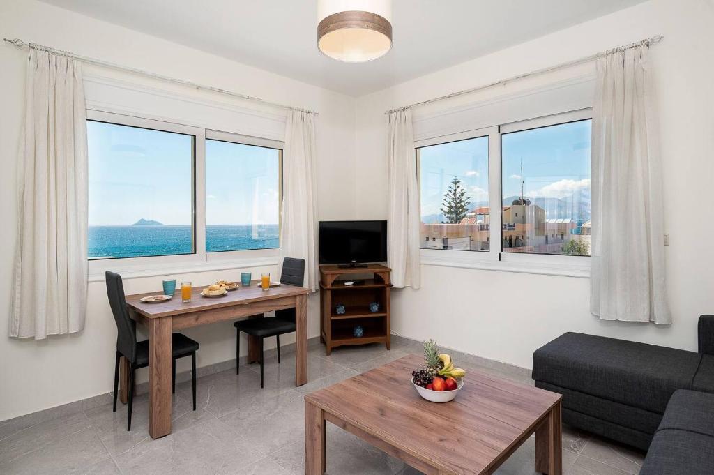 a living room with a table and a couch at Artemis Seaside House, With Sea View in Kalamaki Heraklion