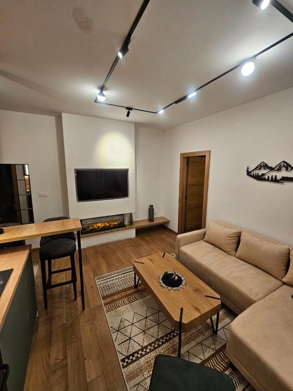 a living room with a couch and a table at Daan dream apart in Kolašin