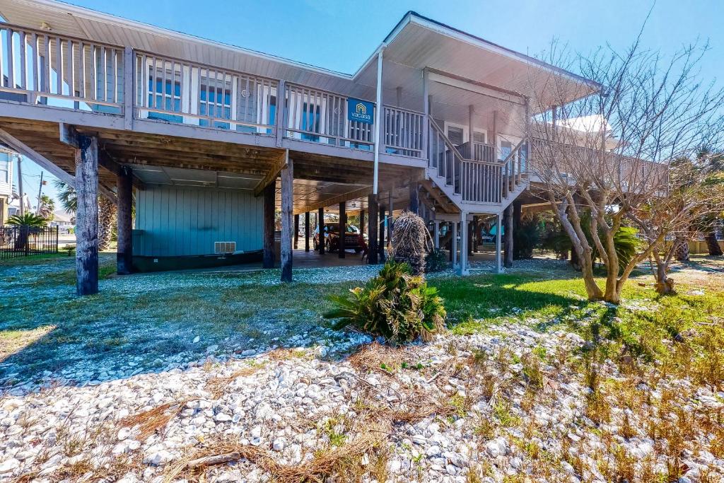 an exterior view of a building with a yard at Bay Dream Believer in Dauphin Island