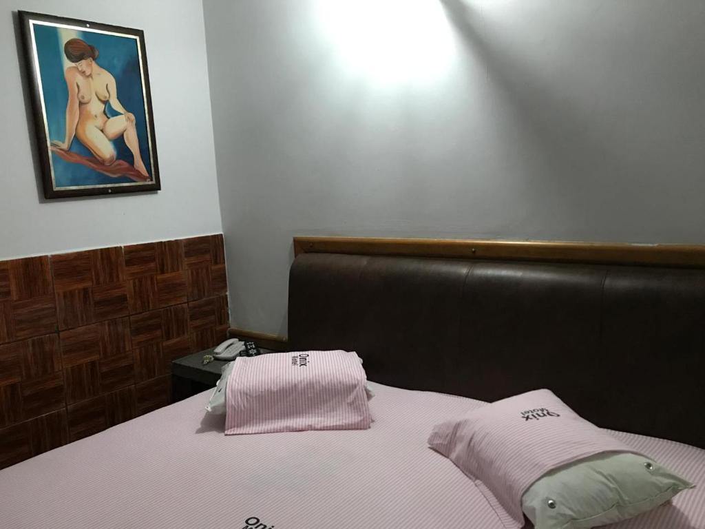 Postel nebo postele na pokoji v ubytování Onix Motel