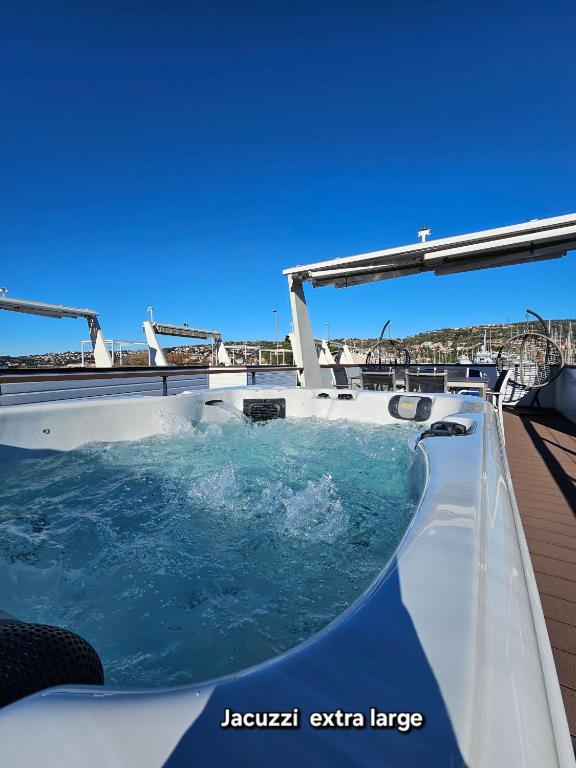 a hot tub on the deck of a boat at Sea Diva - luxury boathouse in Portorož