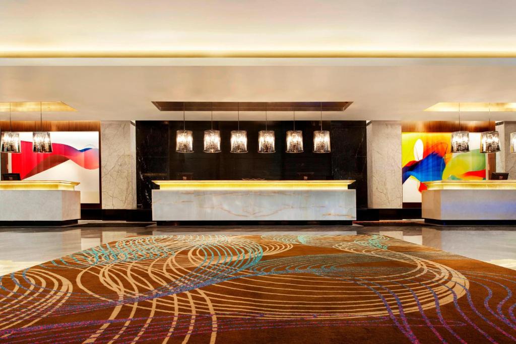 a lobby with a large rug on the floor at Le Meridien Coimbatore in Coimbatore