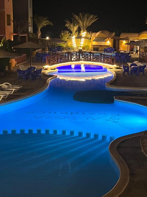 a swimming pool at night with blue lights at Al-Dora Resort Hurghada in Hurghada