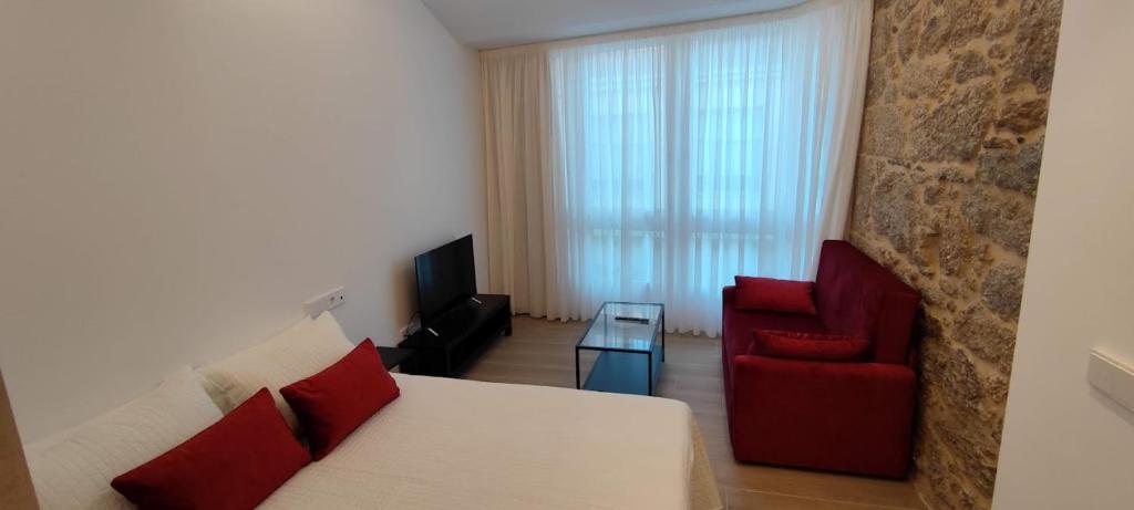 Televízia a/alebo spoločenská miestnosť v ubytovaní Apartamentos A pousa do Asma