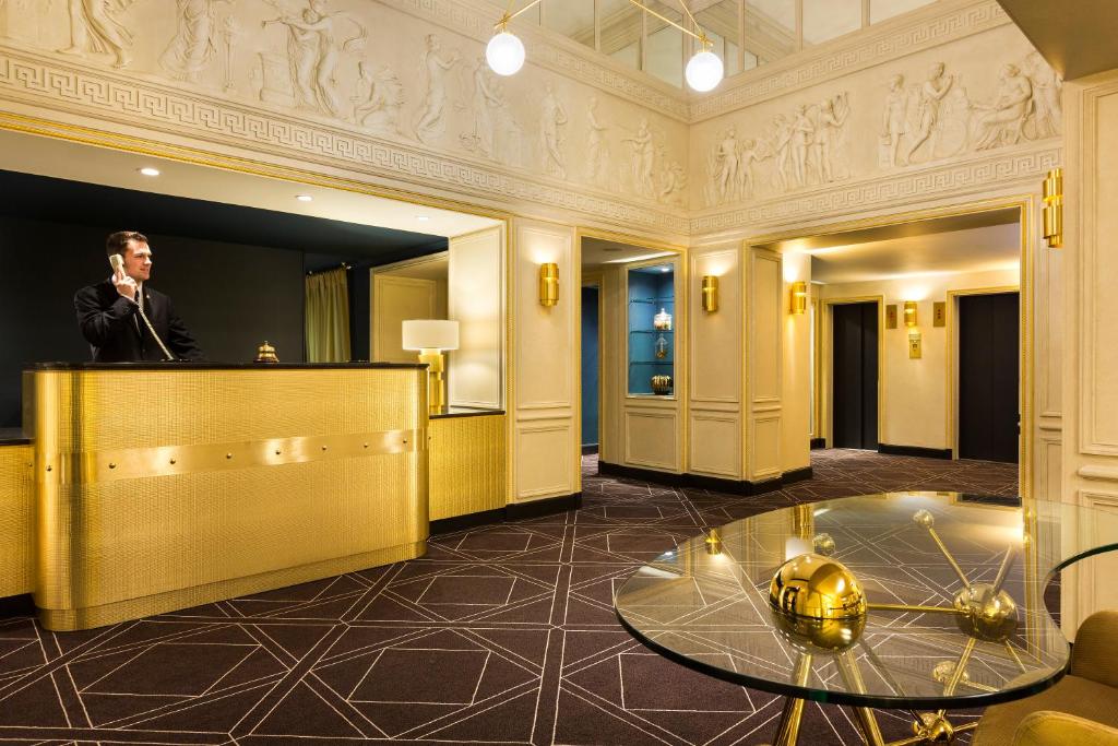 a man standing at a podium in a lobby at Hotel Barsey by Warwick in Brussels