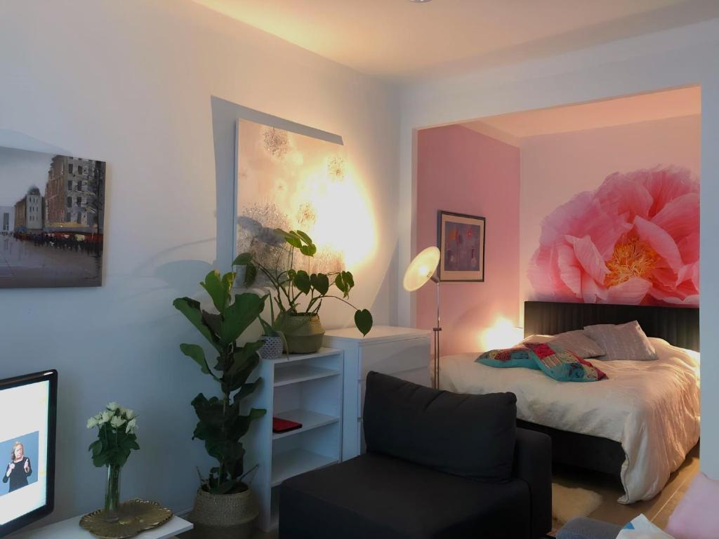 a bedroom with a bed and a chair in it at Lovely Flat in the Heart of Helsinki in Helsinki