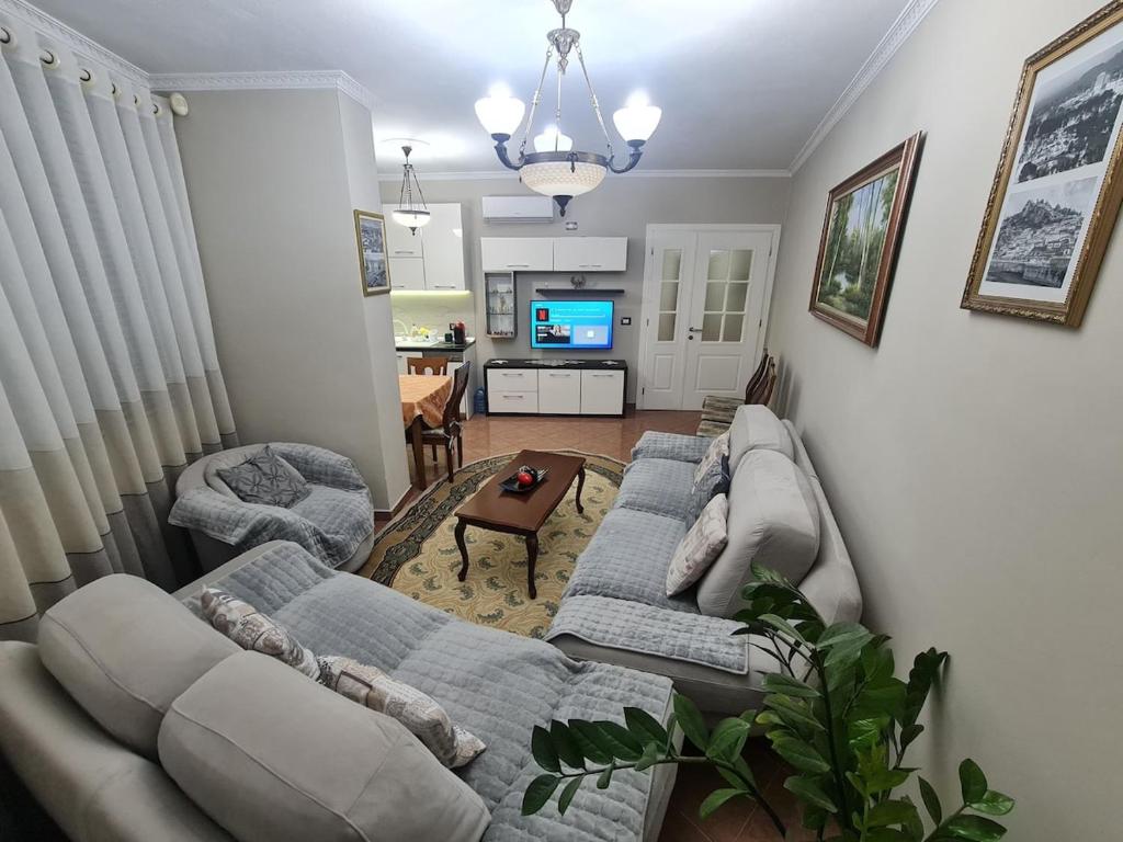 a living room with two couches and a tv at Tirana Center in Tirana