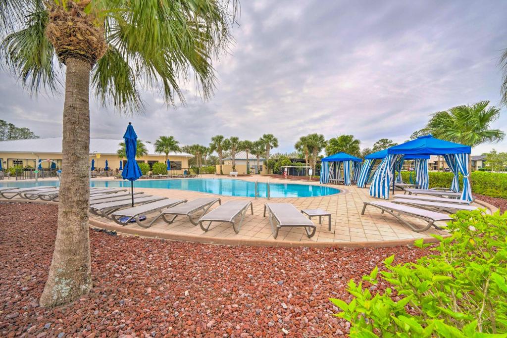a swimming pool with lounge chairs and a palm tree at 1 Mi to Links! Resort Home Near Raceway in Sebring in Sebring