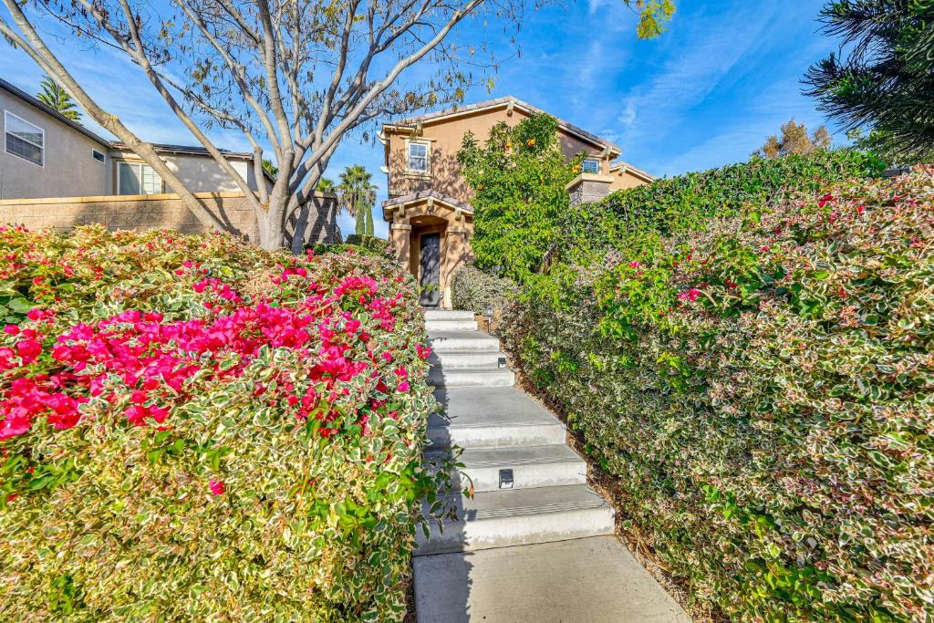 a garden with pink flowers in front of a house at 20 Mi to Old Town San Diego Stay and Play! in Chula Vista