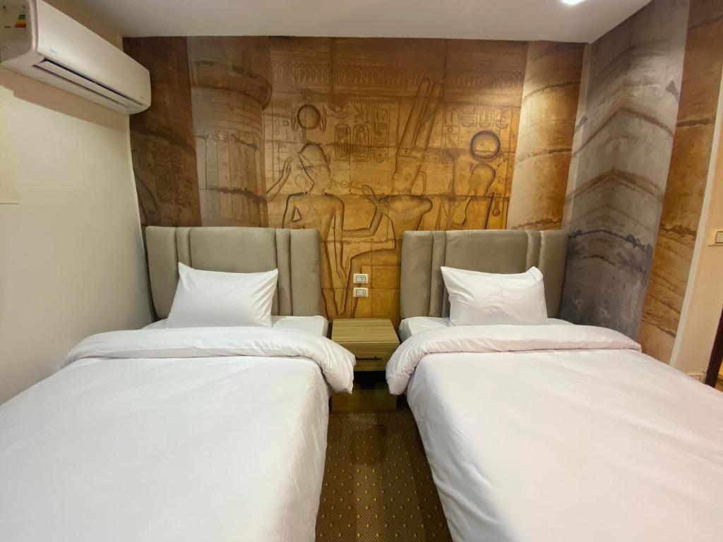 Postel nebo postele na pokoji v ubytování Royal Golden Pyramids Inn
