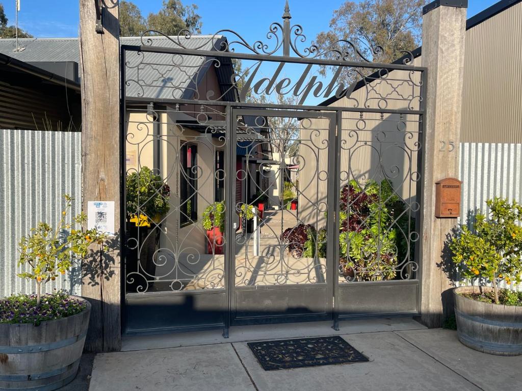 a gate with plants in it in a garden at Adelphi Apartments 1 or 1A in Echuca