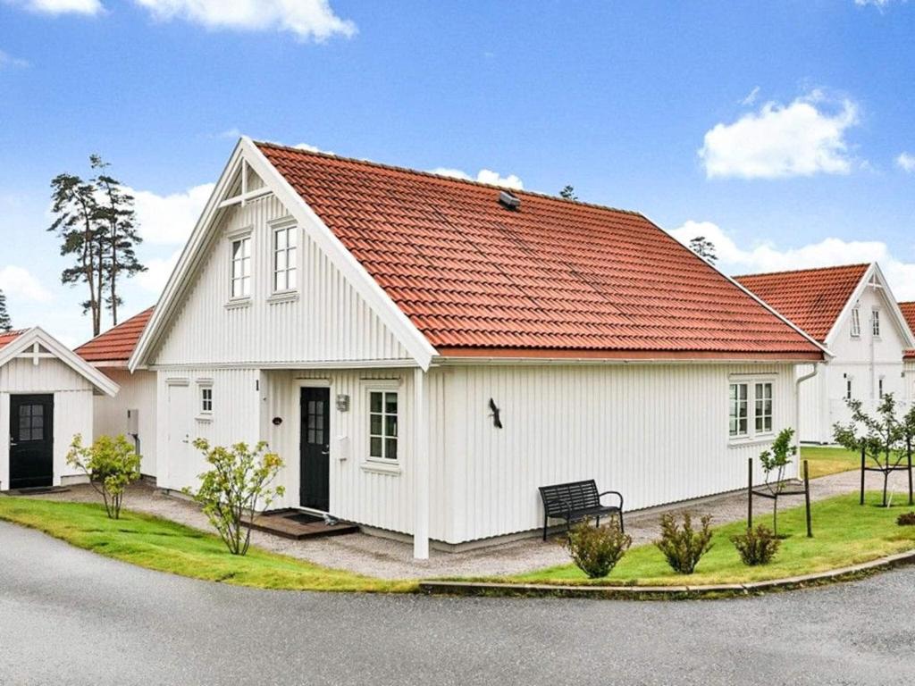 a white house with an orange roof at 5 star holiday home in ENGELSVIKEN in Saltnes
