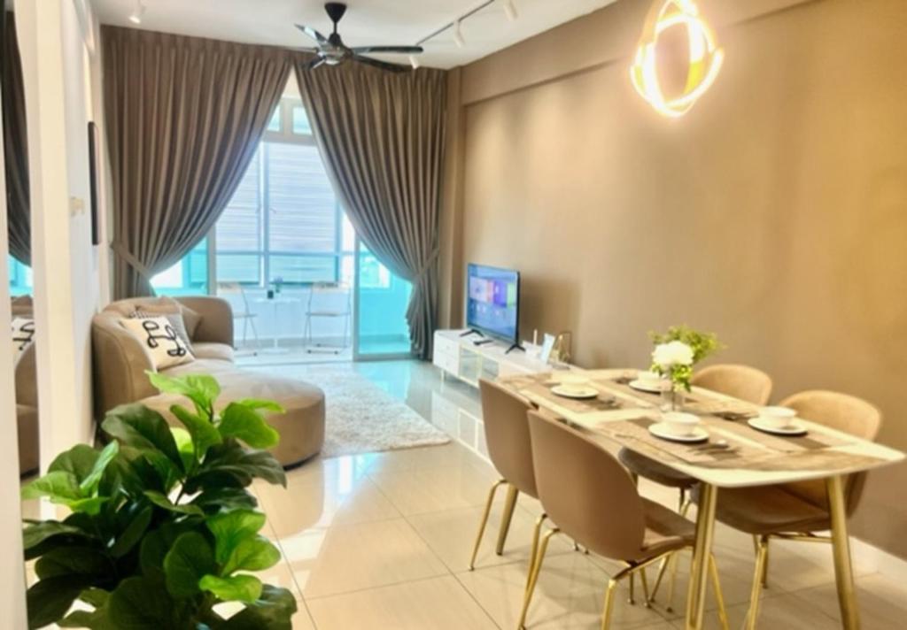 a living room with a table and chairs and a couch at Furusato Midori Green- Tmn Mount Austin at Johor Bahru in Johor Bahru