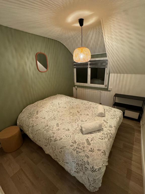 a bedroom with a bed and a window at Maison de pêcheur avec extérieur in Étaples