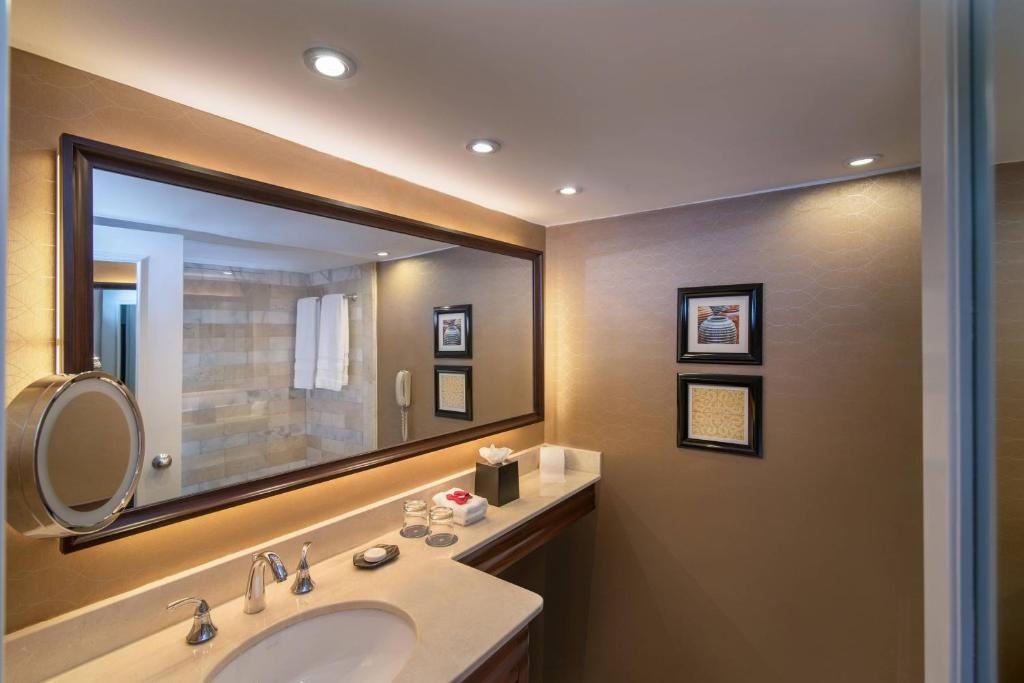 a bathroom with a sink and a large mirror at Sheraton Santo Domingo in Santo Domingo