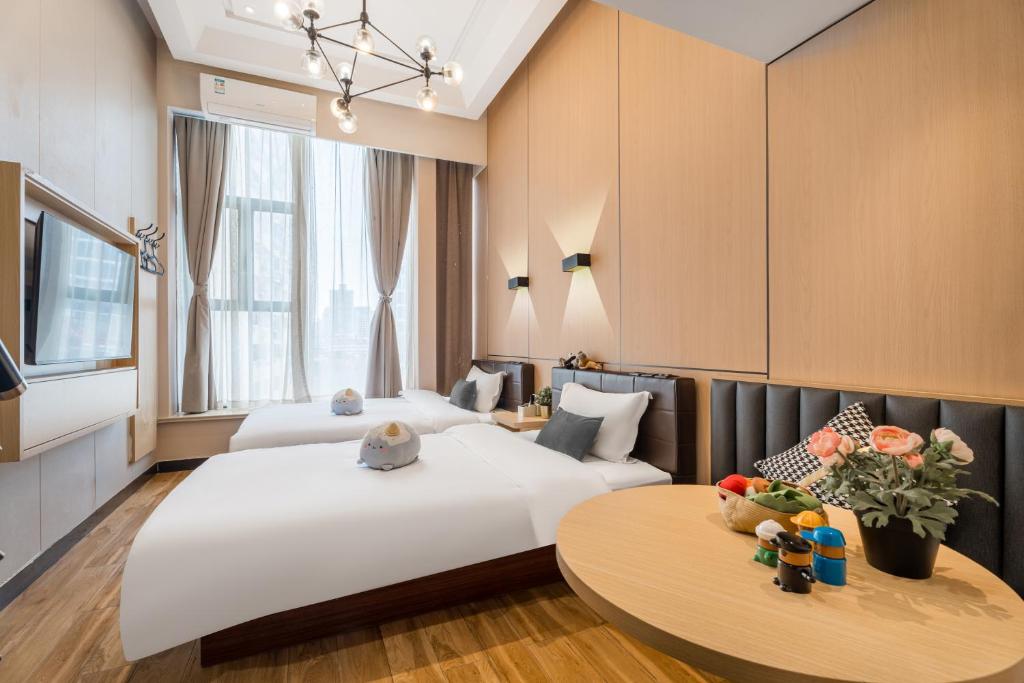 Postel nebo postele na pokoji v ubytování Shanghai Meego Qingwen Hotel