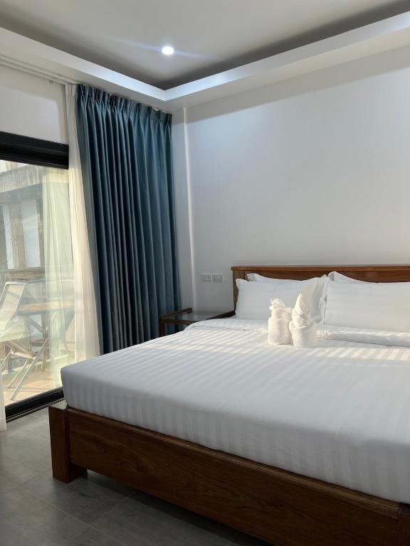 Postel nebo postele na pokoji v ubytování Ocean Star Hotel Coron